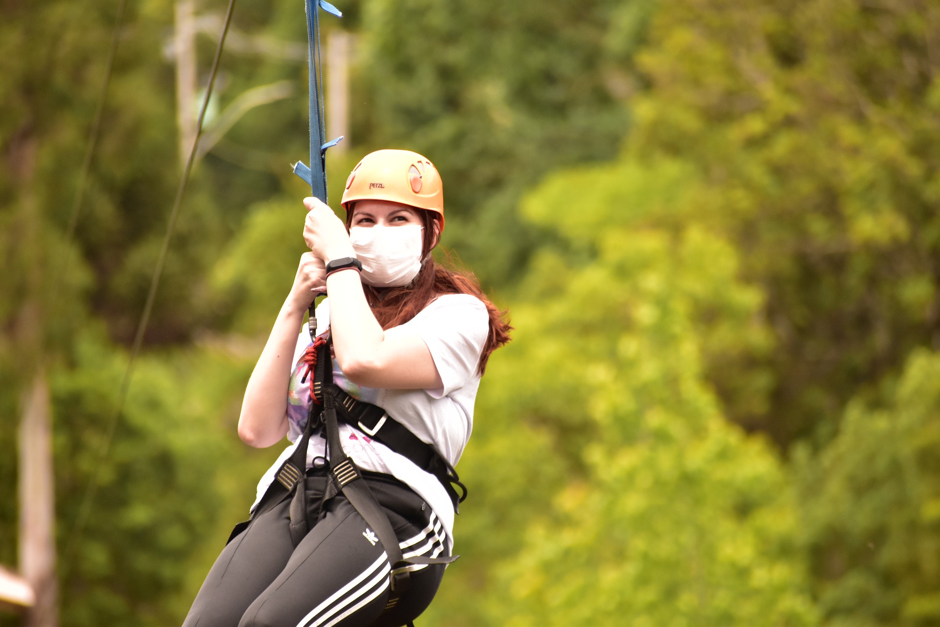 zipline-woman-6806370_1920 a person wearing a helmet